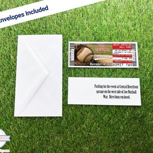 A baseball ticket invitation, front and back, and the white envelopes that are included over a grass background