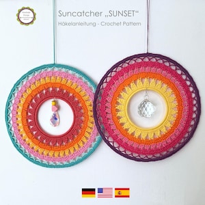 May include: Two handmade crochet suncatchers in a sunset colour scheme. Each circular design features concentric rings of colour, including pink, orange, yellow, and teal. One has a crystal pendant, the other a pink and yellow pendant. Text reads "Suncatcher, SUNSET".
