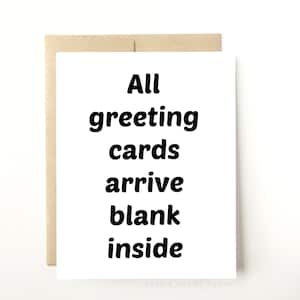 May include: A white greeting card with black text that reads "All greeting cards arrive blank inside". The card is on a brown envelope.
