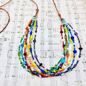 Rainbow beads, pearls, Sterling Silver Multi strand necklace on leather cord with slide closure. ROYGBIV beads on leather. Boho necklace.
