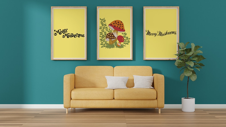Puede incluir: Tres impresiones enmarcadas con fondo amarillo y texto negro que dice "Merry Mushrooms". La impresi&oacute;n central presenta una ilustraci&oacute;n de hongo con acentos rojos y marrones y hojas verdes. Las impresiones est&aacute;n colgadas en una pared azul verdosa sobre un sof&aacute; amarillo.