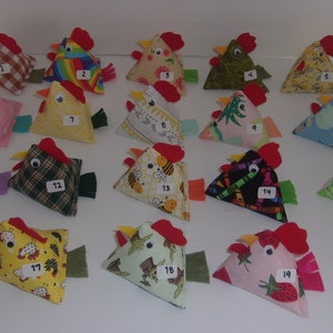 May include: Twenty handmade fabric chickens in various colors and patterns, numbered 1 through 20. Each chicken is a triangular shape with a red comb and beak.