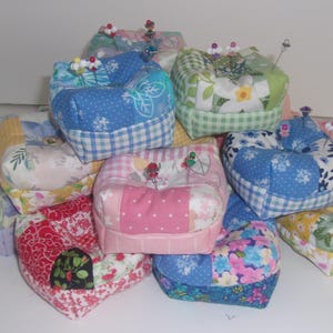 Pincushions, weighted with crushed walnut shells in patchwork prints. 3 1/4&quot; W x 1 1/4&quot; H. Cotton fabric.