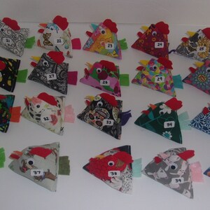 May include: A collection of 40 handmade fabric chickens, each with a unique design and numbered. The chickens are all triangular in shape and have red felt combs and wattles.
