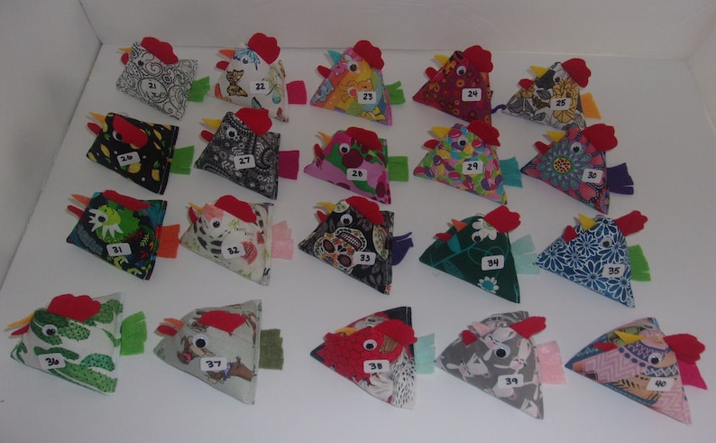 May include: A collection of 40 handmade fabric chickens, each with a unique design and numbered. The chickens are all triangular in shape and have red felt combs and wattles.