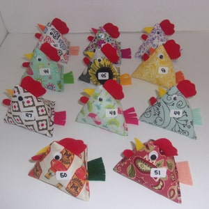 May include: A collection of 10 handmade felt chicken ornaments. Each chicken is a different color and pattern, with a red felt beak and comb. The chickens are numbered 41 through 51.