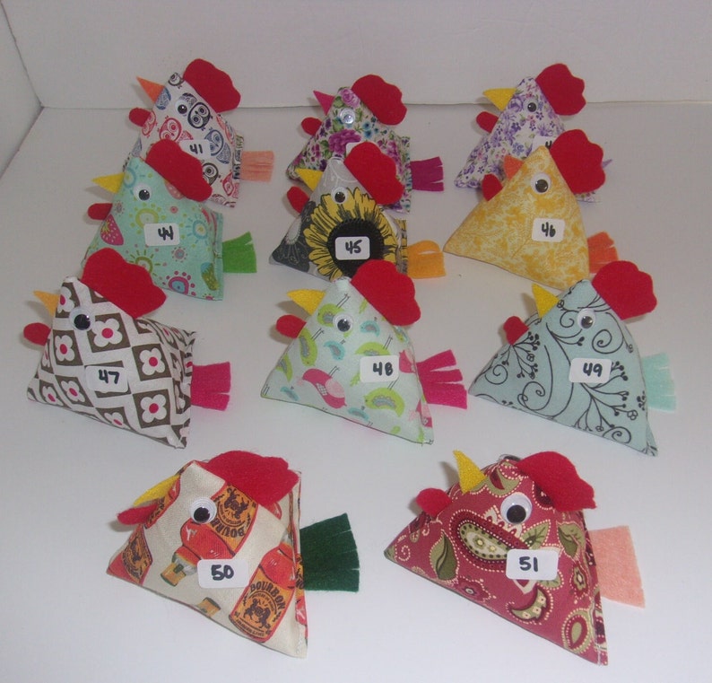 May include: A collection of 10 handmade felt chicken ornaments. Each chicken is a different color and pattern, with a red felt beak and comb. The chickens are numbered 41 through 51.