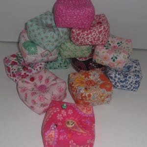 Pincushions, weighted with crushed walnut shells. 3 1/4" W x 1 1/4" H. Cotton fabric, many print selections