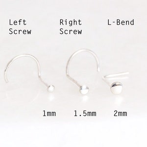 May include: Three nose rings in silver, with different styles: a left screw, a right screw, and an L-bend. The rings are shown with their corresponding sizes: 1 mm, 1.5 mm, and 2 mm.