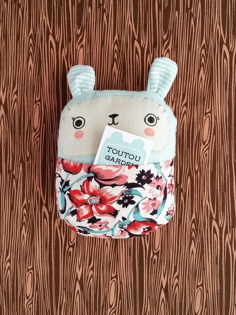 Stuffed bunny soft baby toy with bold floral front pouch. | Etsy