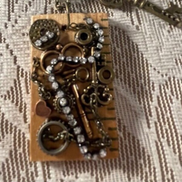 Vintage  Piece of Yardstick, With Rhinestones and Charms.  Necklace In Antique Bronze Tone.