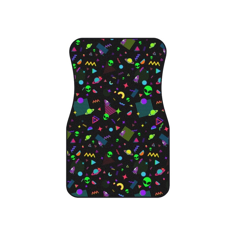May include: Black car floor mat with a colorful pattern of aliens, planets, and geometric shapes in neon colors.
