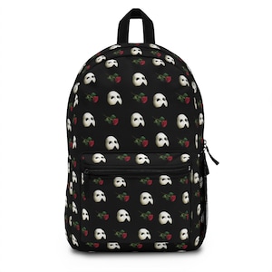 May include: Black backpack with a repeating pattern of white Phantom of the Opera masks and red roses.