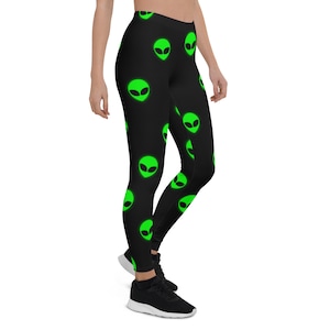 May include: Black leggings with a repeating pattern of green alien faces.