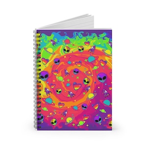 May include: A spiral bound notebook with a colorful psychedelic design featuring aliens, hearts, planets, and rockets. The background is a swirling rainbow of colors.