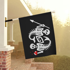 May include: A black pirate flag with a white design of two skeletons with mermaid tails holding a spear. The skeletons are facing each other and have a red heart between them.