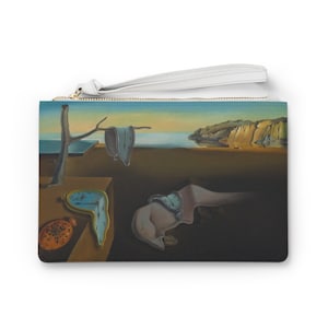 May include: A white clutch purse with a zipper closure features a printed image of Salvador Dali's "The Persistence of Memory". The painting depicts a surreal landscape with melting clocks, a tree, and a rocky cliff.