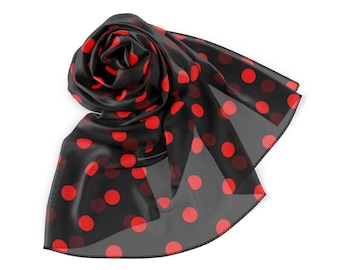 May include: A black sheer scarf with red polka dots. The scarf is folded and tied into a knot.