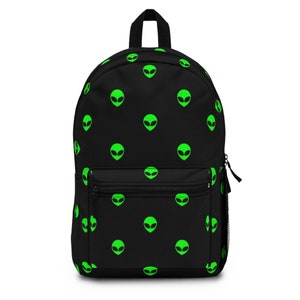 May include: Black backpack with a repeating pattern of green alien heads.