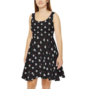 May include: A black skater dress with a white and red print of a phantom mask and roses.