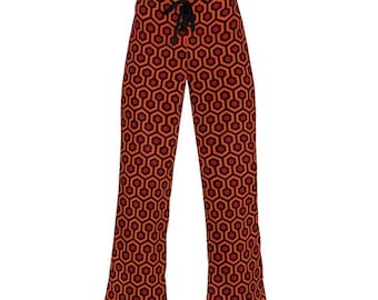 May include: Orange and black patterned pajama pants with a black drawstring.