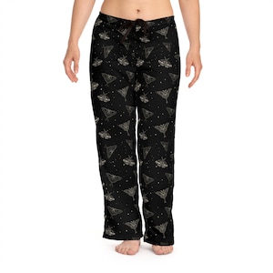 May include: Black pajama pants with a pattern of gold moths and stars.