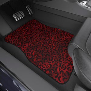 May include: Red and black leopard print car floor mat. The mat is made of a soft, durable material and is designed to protect your car's interior from dirt, spills, and wear and tear.