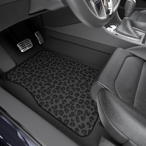May include: Black and gray leopard print car floor mats. The mats are made of a durable material and are designed to protect your car's interior from dirt, spills, and wear and tear.