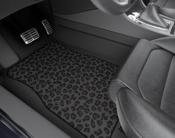 May include: Black and gray leopard print car floor mats. The mats are made of a durable material and are designed to protect your car's interior from dirt, spills, and wear and tear.