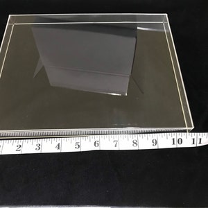May include: A clear acrylic display case with a ruler measuring 11 inches in length.