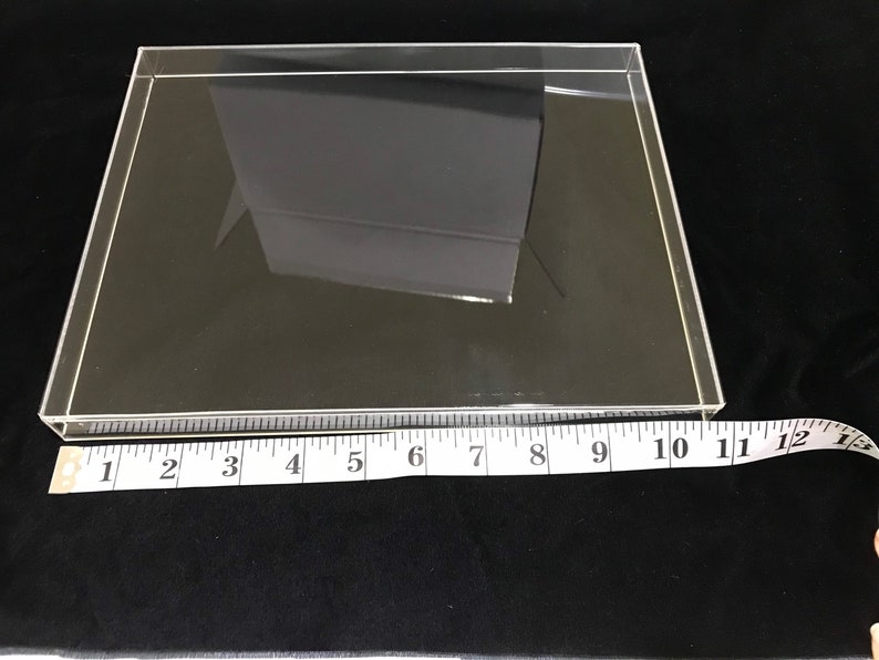 May include: A clear acrylic display case with a ruler measuring 11 inches in length.
