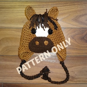 May include: Crocheted brown horse hat with white and brown accents. The hat has a long tail and the text "PATTERN ONLY" is visible on the image.