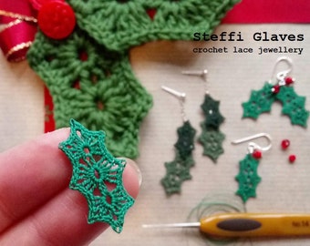 May include: Green crochet holly leaf earrings with red beads. The earrings are handmade and are part of a set of crochet jewelry. The text "Steffi Glaves crochet lace jewellery" is visible in the image.