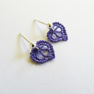 May include: A pair of purple crocheted leaf earrings with silver posts and beads.
