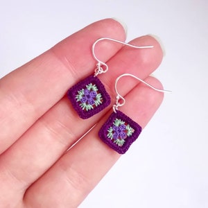 May include: Purple and green crochet square earrings with silver hooks.