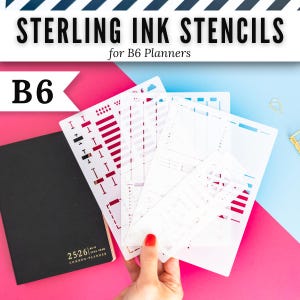 May include: A set of white plastic stencils labeled Sterling Ink Stencils for B6 Planners, featuring various cutouts for tracking and scheduling, alongside a black planner with the text 25-26 Common-Planner printed in gold on the cover.