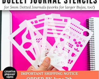 May include: A set of four translucent white plastic bullet journal stencils featuring various cutouts including geometric shapes, lines, icons, and weather symbols. The text BULLET JOURNAL STENCILS for 5mm Dotted Journals is printed at the top of the image.