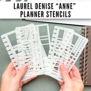 May include: A set of white, semi-transparent plastic planner stencils labeled Laurel Denise Anne Planner Stencils. The stencils feature various cut-out shapes including rectangles, circles, icons, and lines for organizing daily tasks and schedules.