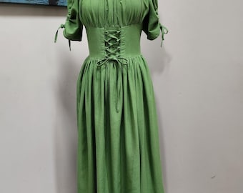 May include: A green, long-sleeved dress with a square neckline and a lace-up corset bodice. The dress has a gathered skirt and is made of a lightweight fabric.