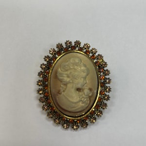 Cameo reproduction brooch. Topaz rhinestones. Gilded Age