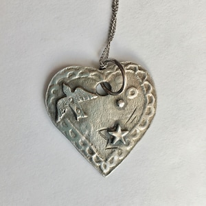 new bird heart pendant in fine silver