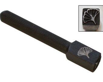 May include: A black metal stamping tool with a ginkgo leaf design. The tool has a textured handle and a square head with the design engraved on it.