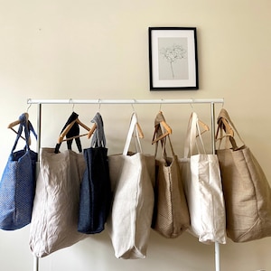 extra large tote bags on hanging rail.