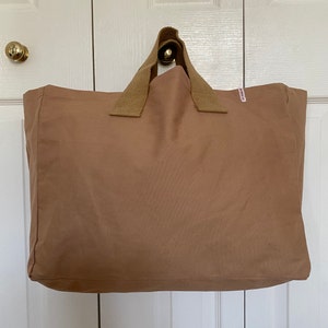 Large brown tote bag with short handles.