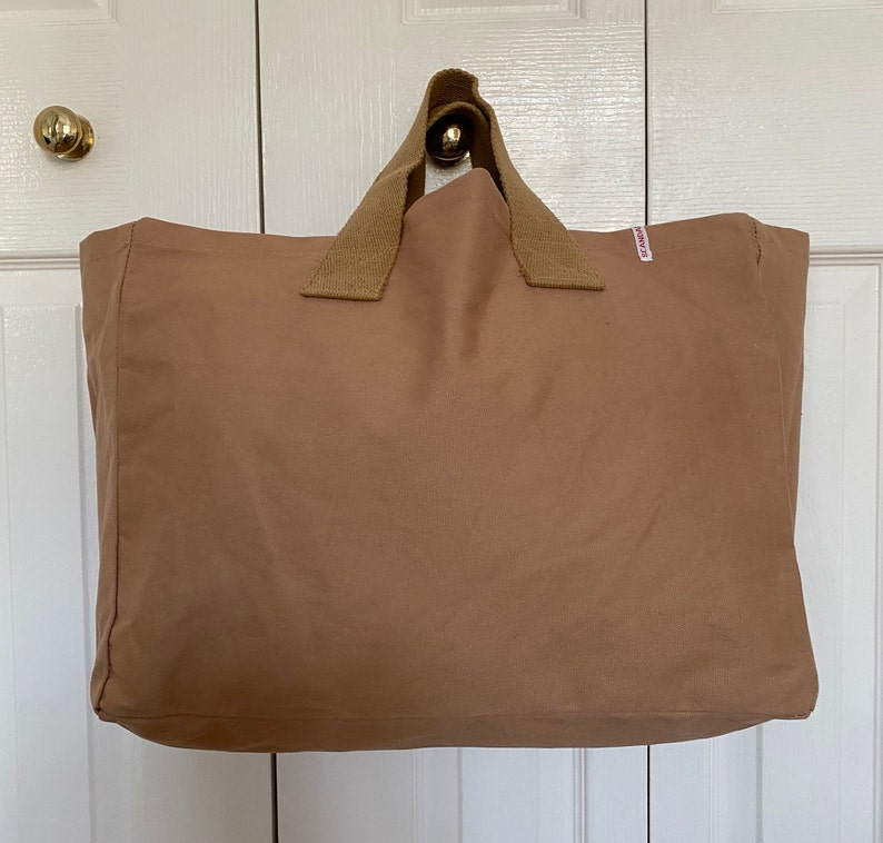 Large brown tote bag with short handles.