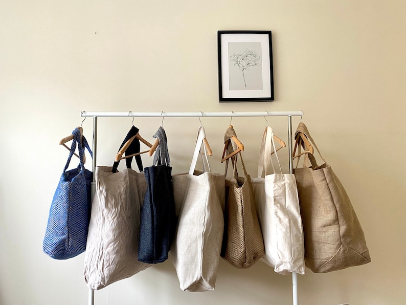 extra large tote bags on hanging rail.