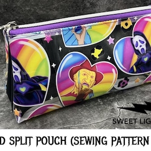 May include: A black zippered pouch with a clear vinyl front. The pouch features a colorful design with rainbow hearts, stars, and characters from horror movies. The text "Wicked Split Pouch (Sewing Pattern Only)" is printed at the bottom of the image.