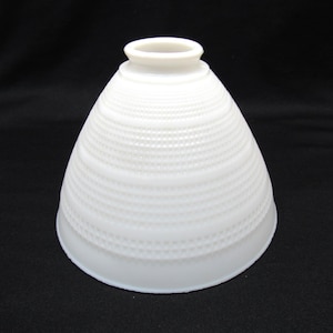 May include: A white ceramic mug with a black handle and the text "But First, Coffee" in a black, handwritten-style font. The mug is on a white surface.