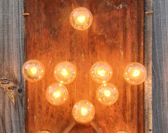 Tin Star lighted wall art on naturaly rusted antique tin roof shingle, carnival light bulbs