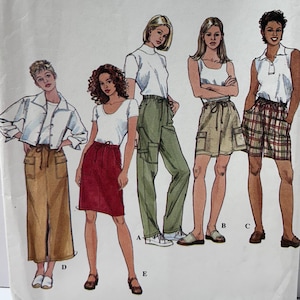 May include: A Simplicity sewing pattern envelope, number 8526, size P (12, 14, 16). The front features illustrations of five different clothing styles, including a long skirt, a knee-length skirt, cargo pants, and two pairs of shorts, all paired with various tops.